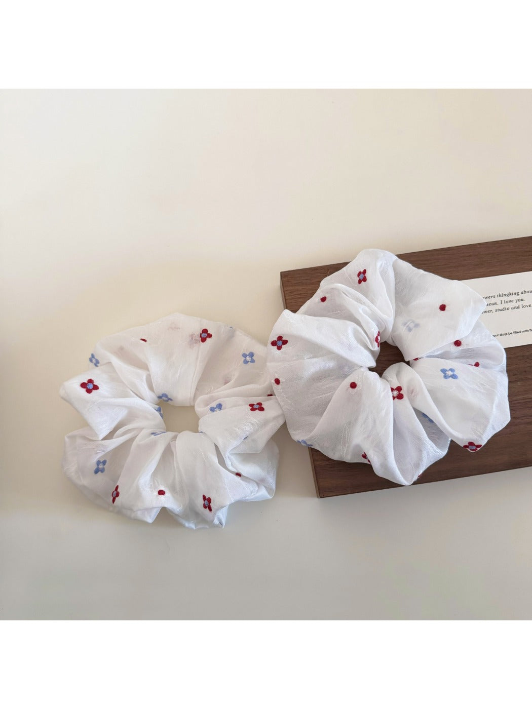 White flower scrunchie worn in hair with natural lighting