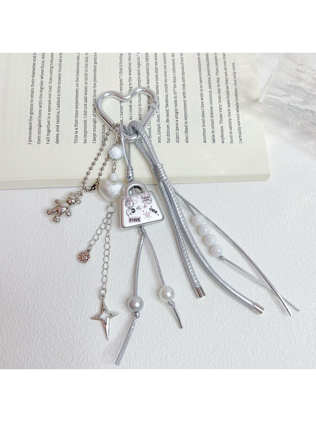 Keypus cute bag charm keychain displayed with other accessories on a wooden surface
