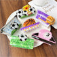 Close-up of Beau claw clip designed as a soccer ball with black and white panels
