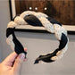 Vintage knitted twist headband displayed flat highlighting twisted design
