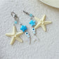 Keychain displayed hanging with starfish and fish charms visible