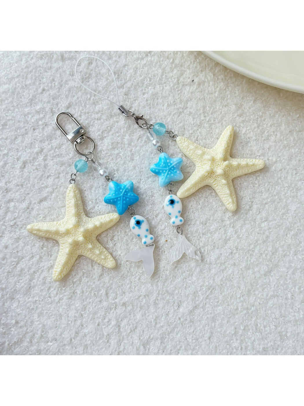Keychain displayed hanging with starfish and fish charms visible