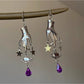 Close-up of Earedge Magic Hand Pendant Earrings with gold-tone finish