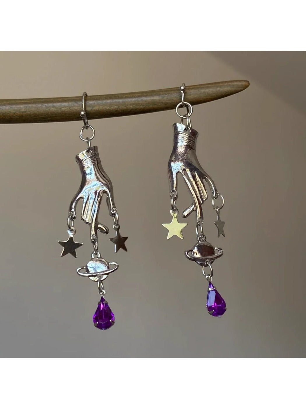 Close-up of Earedge Magic Hand Pendant Earrings with gold-tone finish