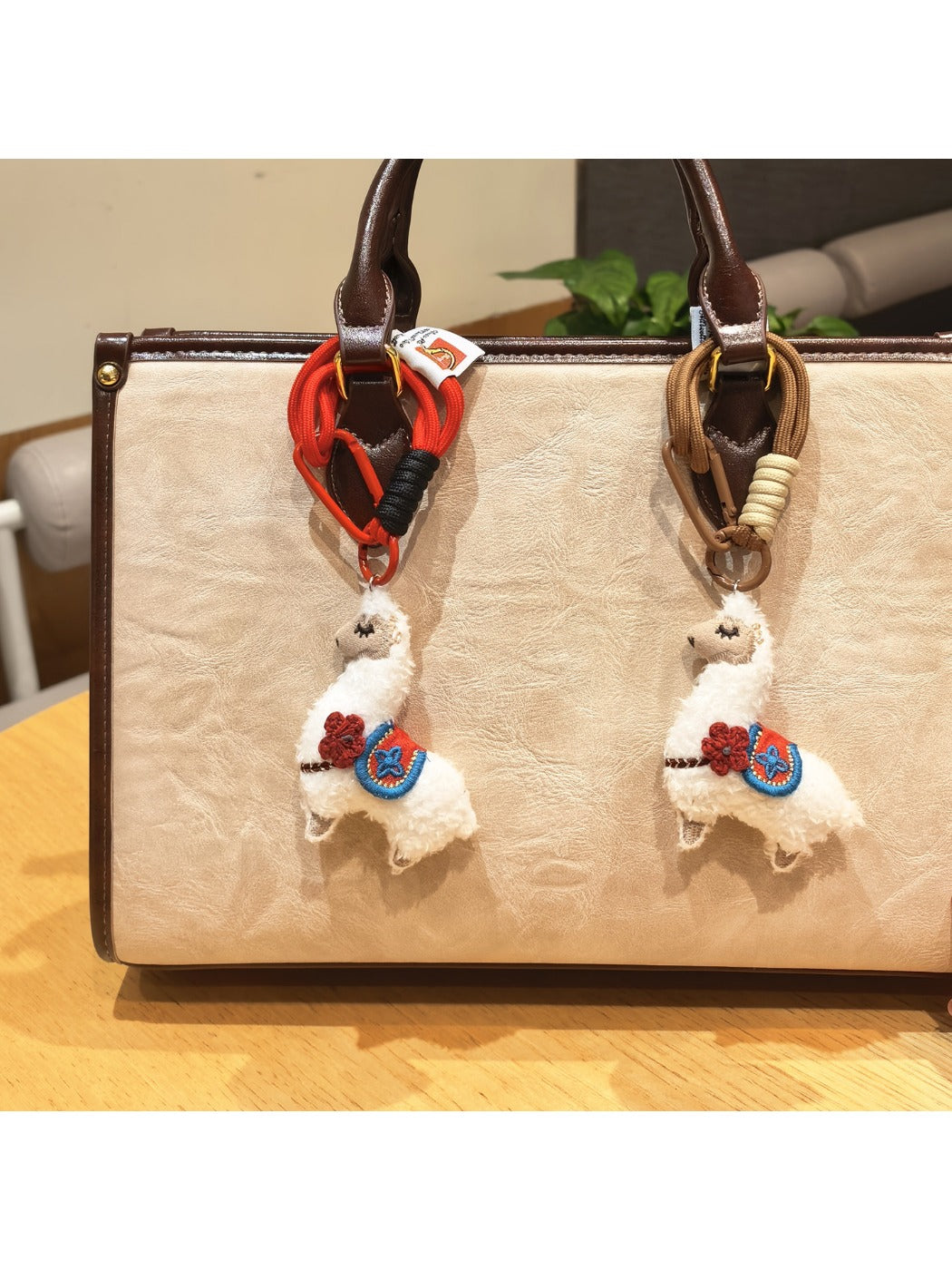 Side view of the alpaca keychain showing detailed stitching and fluffy texture