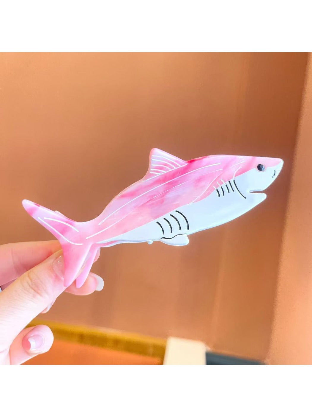 Beau shark shape claw clip in natural light on white background