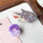 Close-up of Beau claw clip showing vibrant shark and octopus design