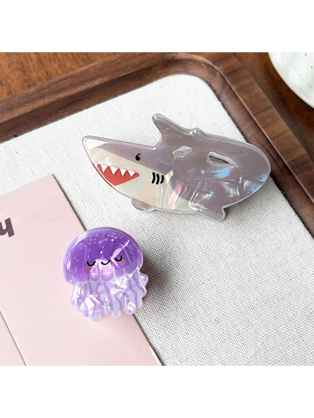 Close-up of Beau claw clip showing vibrant shark and octopus design