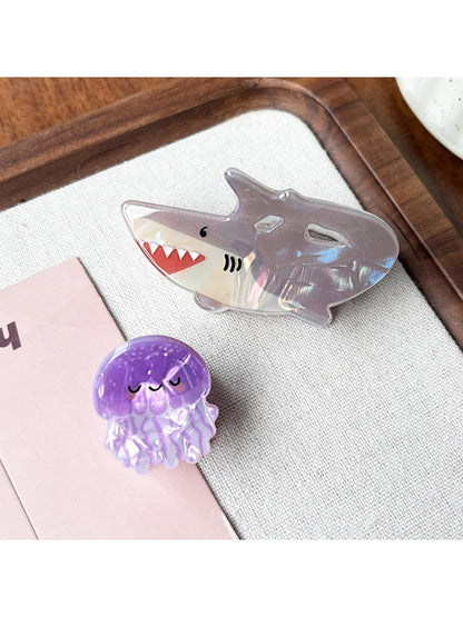 Close-up of Beau claw clip showing vibrant shark and octopus design