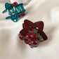 Beau star shaped hair claw clip holding a section of blonde hair