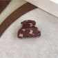 Beau claw clip attached to hair, showcasing butterfly print and grip