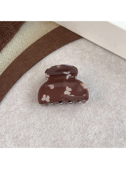 Beau claw clip attached to hair, showcasing butterfly print and grip