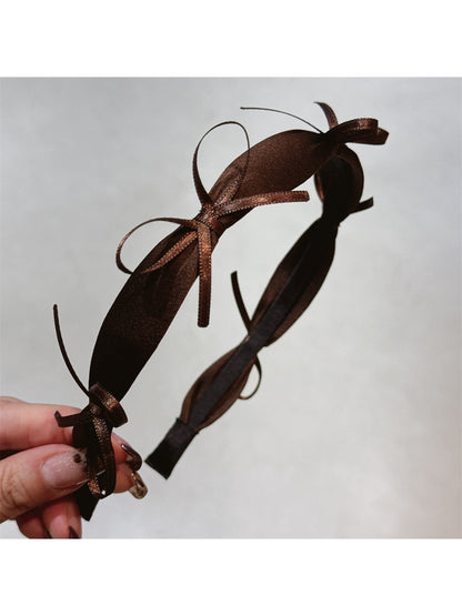 Top view of Gifty ribbon bow headband highlighting bow shape and fabric folds