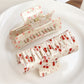 Side view of Beau floral print square hair claw clip highlighting clip mechanism