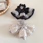 Gifty vintage polka dot hair tie wrapped around a ponytail on a model