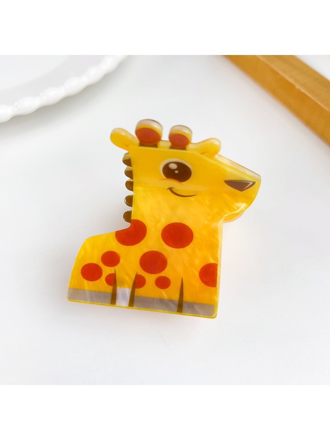 Beau cute animal hair claw clip in beige displayed with other clips