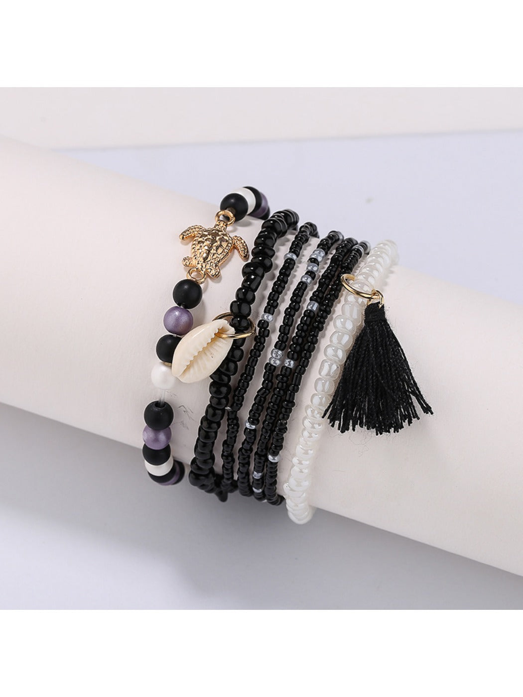 Side angle of Lovra fashionable bracelet featuring colorful beads and small tassel