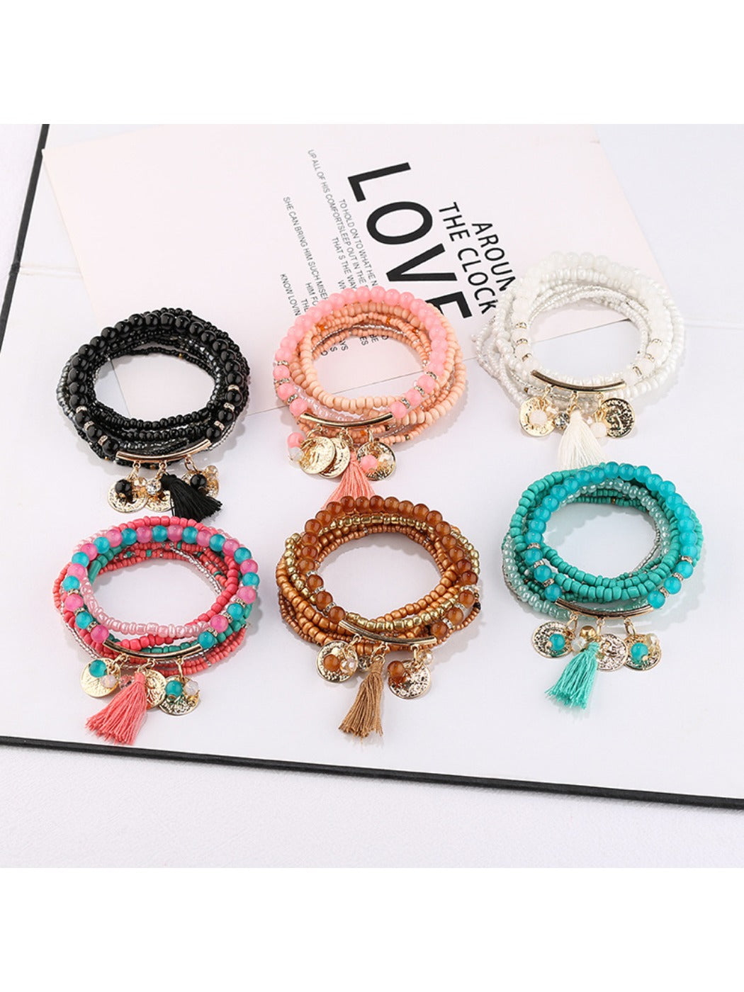 Lovra metal tassel pendant beaded bracelet displayed on a white background