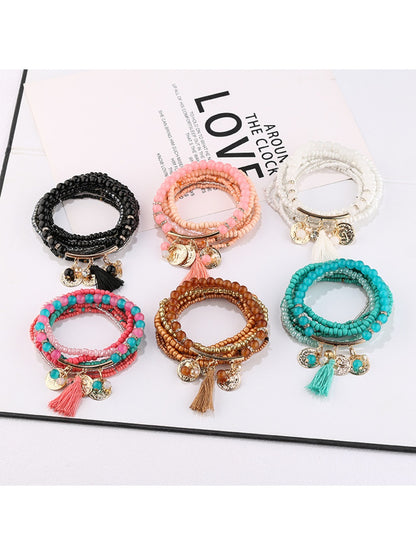 Lovra metal tassel pendant beaded bracelet displayed on a white background