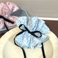 Gifty polka dot bow scrunchie displayed on a white background showing full bow detail