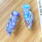 Beau jellyfish shaped claw clip in translucent pastel colors on white background