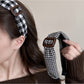 Close-up of black plaid pattern on Gifty clean headband fabric