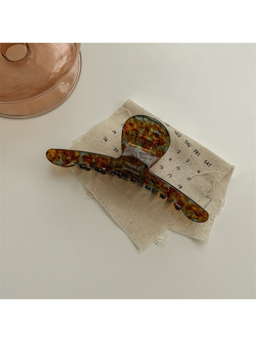 Beau chic acetate claw clip displayed open to show inner spring and teeth