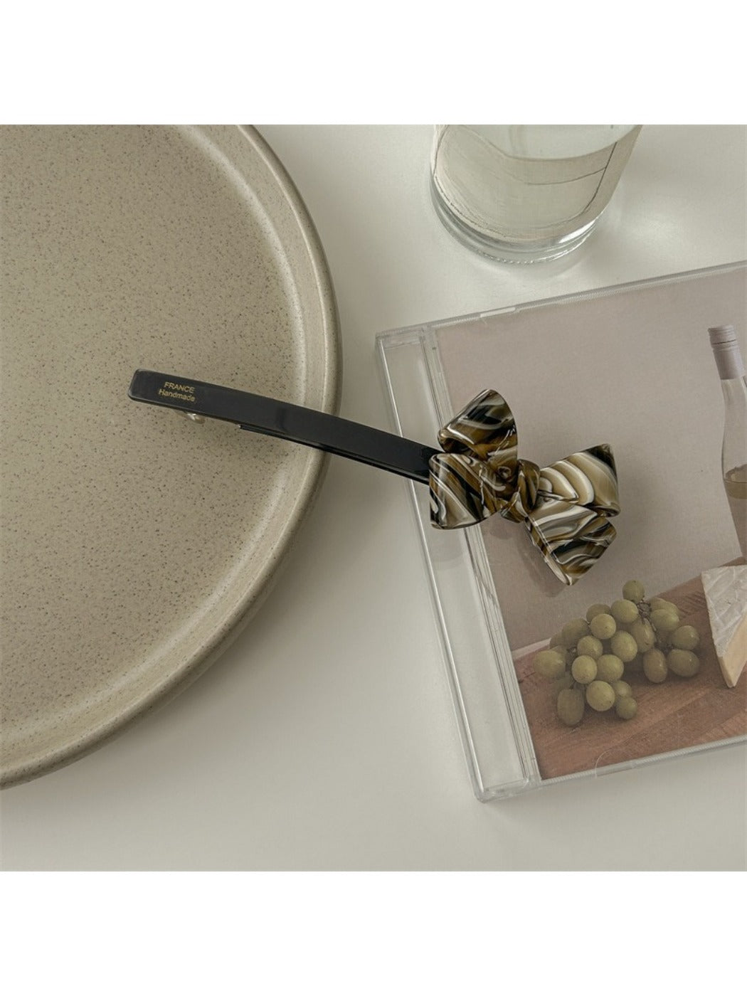 Beau minimalist bow bar hair clip shown with open clasp mechanism