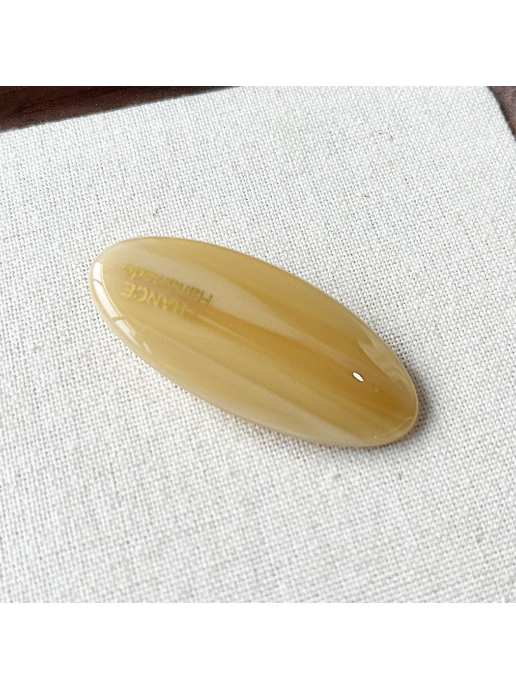 Beau Sweet Oval Acetate Hair Clip next to matching hair accessories