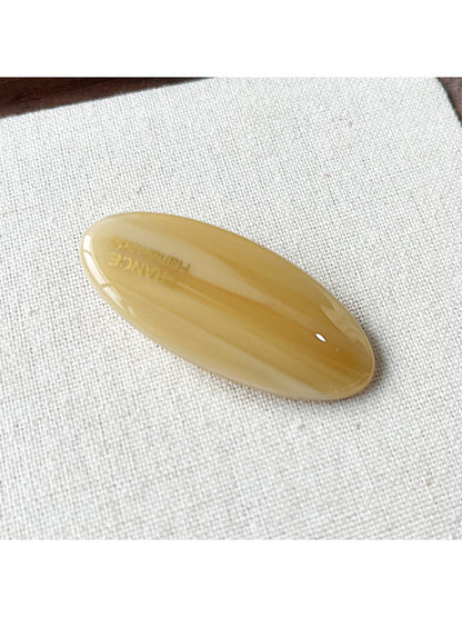 Beau Sweet Oval Acetate Hair Clip next to matching hair accessories