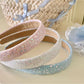 Side view of Gifty Dreamy Sparkly Sweet Headband showing sparkly fabric and bow design