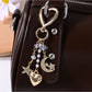 Alloy keychain featuring star, moon, and heart charms on a key ring