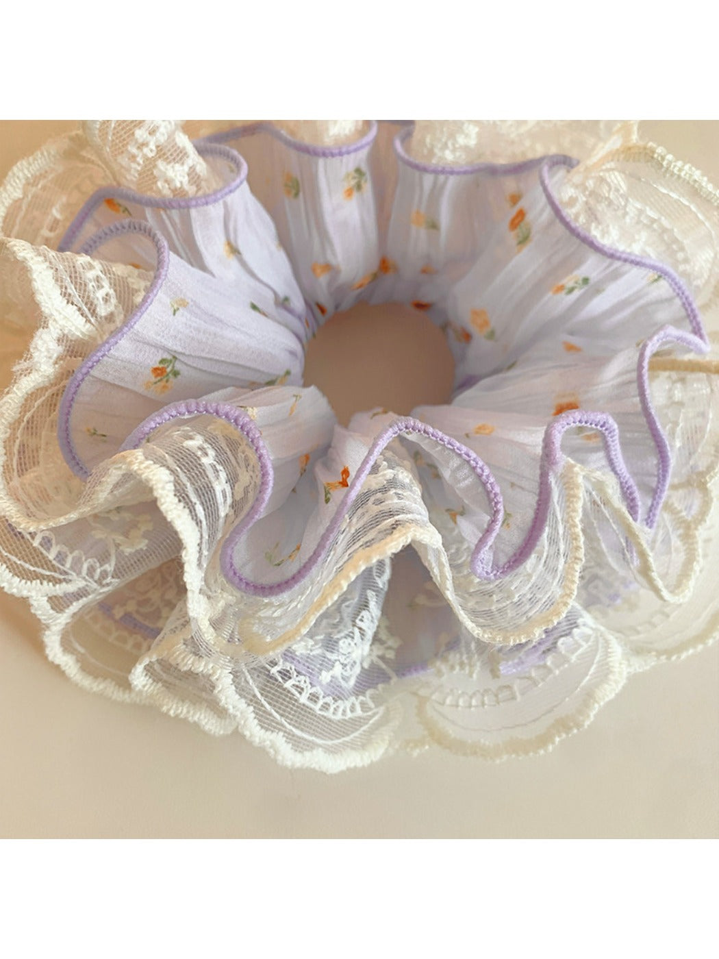 Side view of the purple ruched scrunchie highlighting gathered fabric design