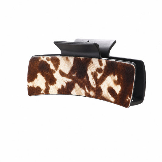 Brown and cream cow-print curved hair claw, side view