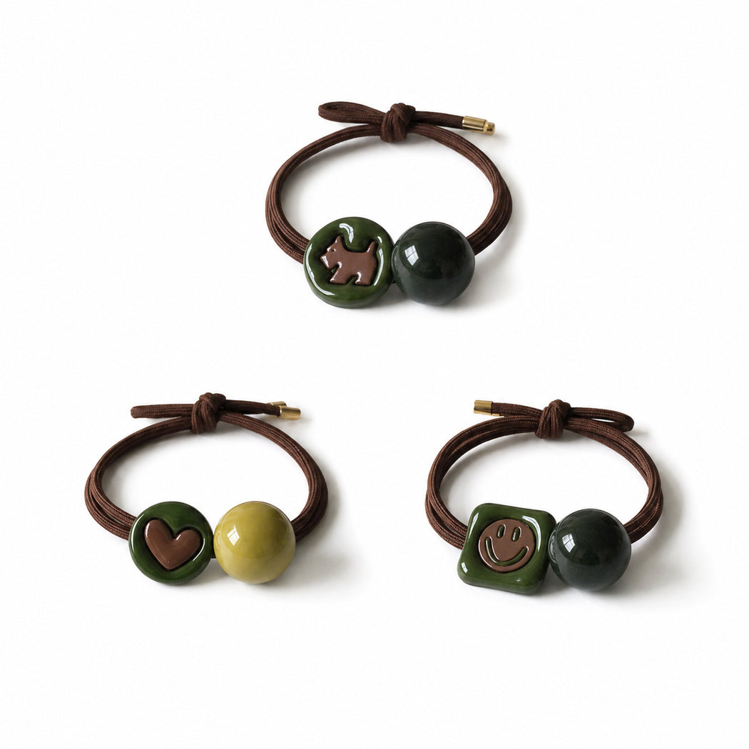 Clean overview of three green charm hair tie variants