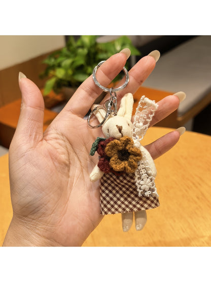 Rabbit charm keychain resting on a leather wallet