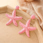 Earedge starfish drop earrings shown from front and side angles