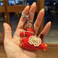 Keypus pony charm keychain next to a notebook and pen on a desk