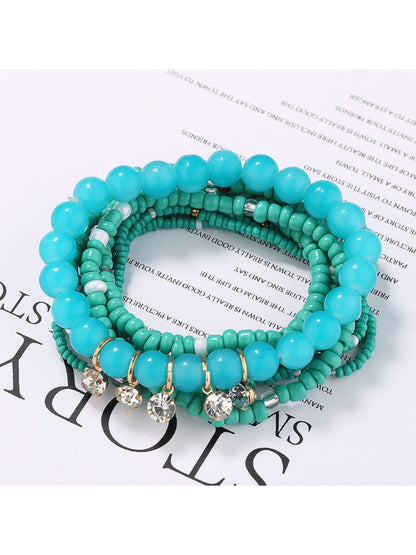 Top view of Lovra rhinestone pendant and colorful beaded bracelet