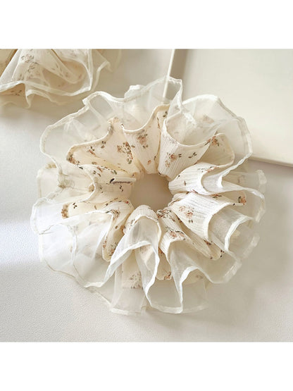 Close-up of Gifty floral print scrunchie showing layered tulle ruffles