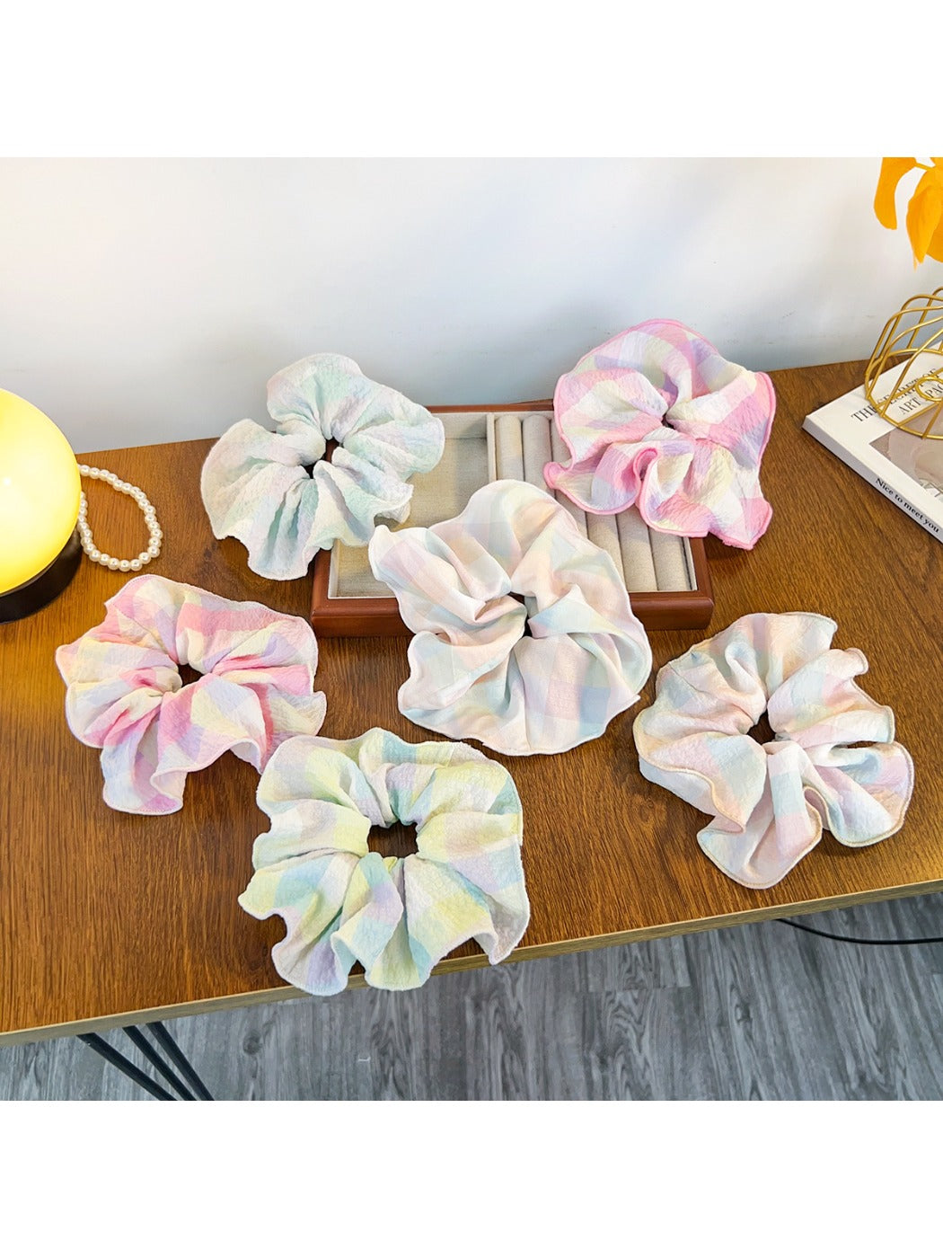 Close-up of Gifty minimalist colorful ruffled scrunchie in pastel pink fabric