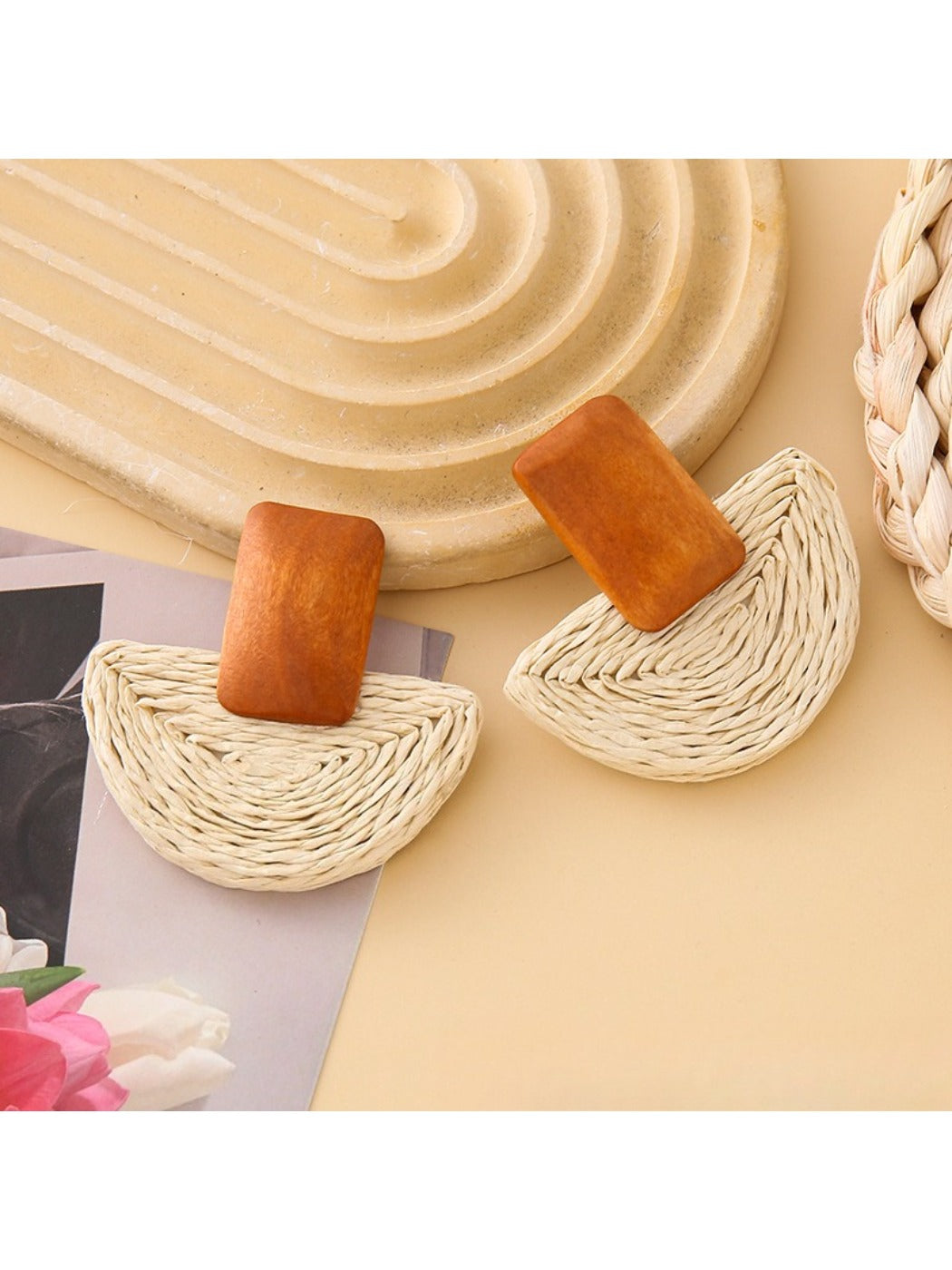 Top view of raffia mushroom shaped stud earrings highlighting woven details