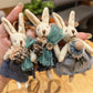 Side view of silver rabbit charm attached to a keyring