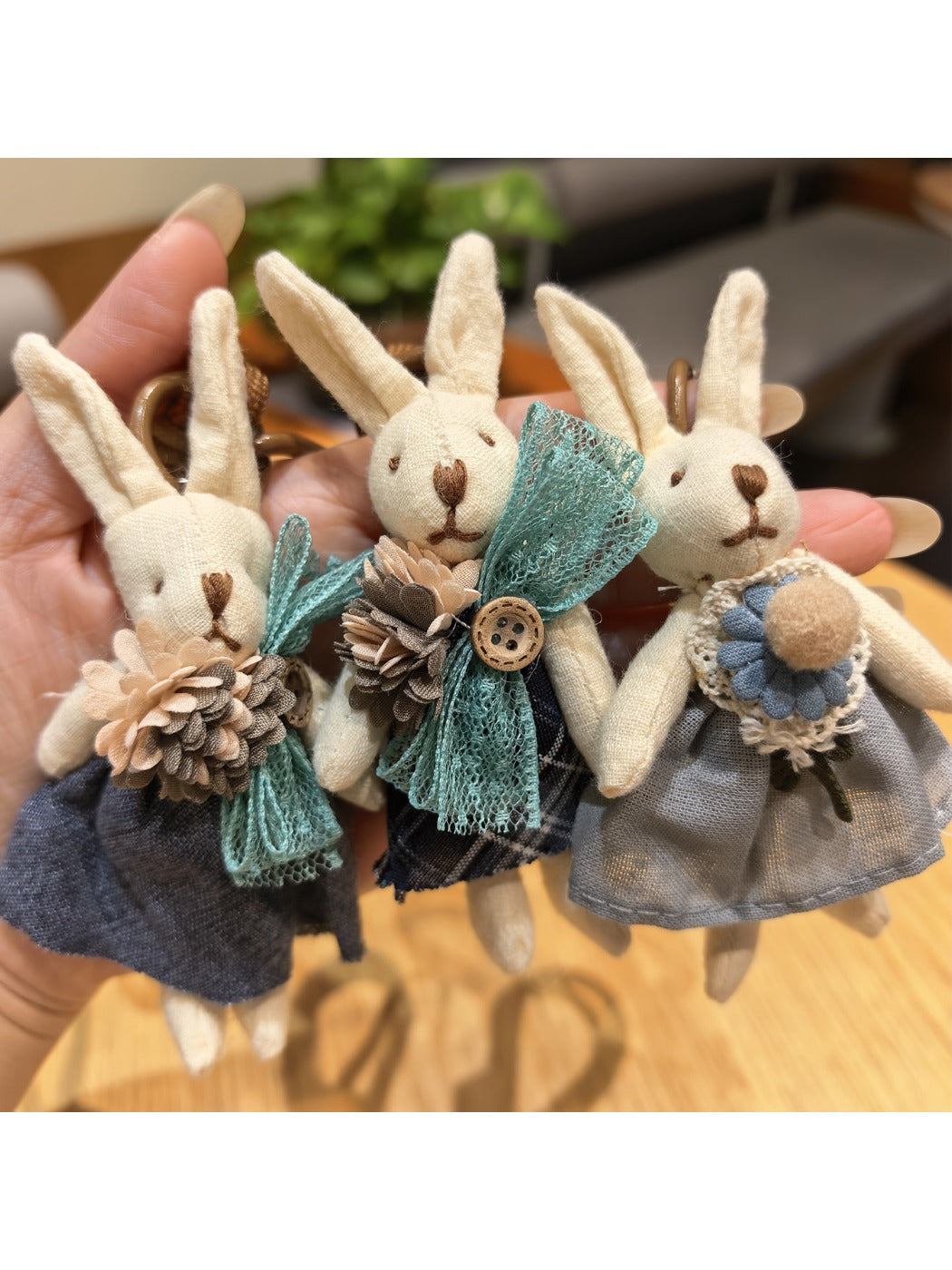 Side view of silver rabbit charm attached to a keyring