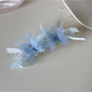 Top view of the banana clip showing symmetrical butterfly decorations along the clip