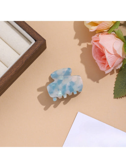 Beau vibrant acetate hair clip styled in long brown hair