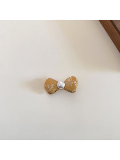 Beau bow hair clip shown next to matching pink accessories