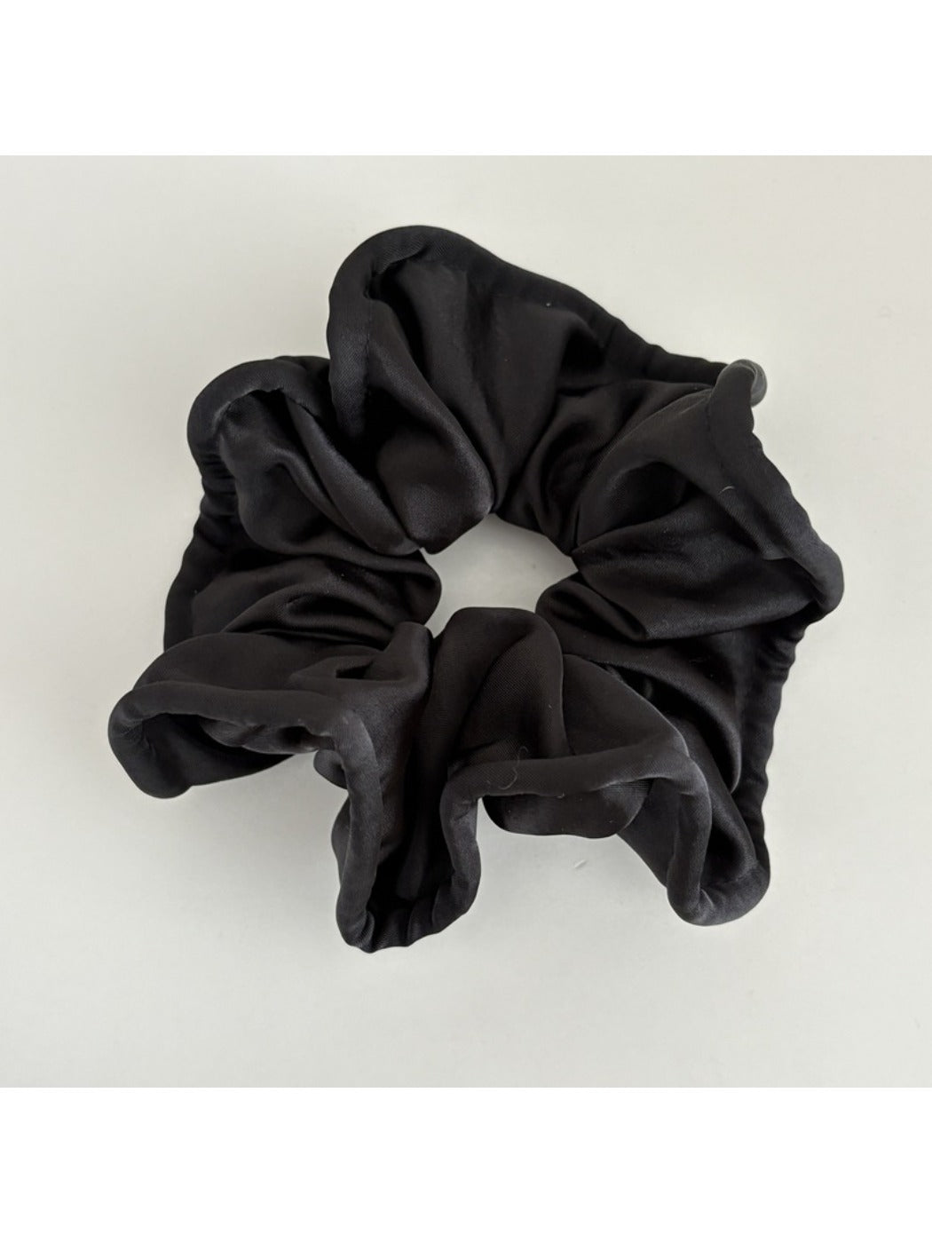 Top view of Gifty silky scrunchie showing circular shape and sheen