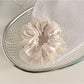 Gifty scrunchie stretched to show elasticity and fabric layers