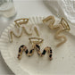 Beau vintage wave line claw clip in tortoiseshell pattern on white background